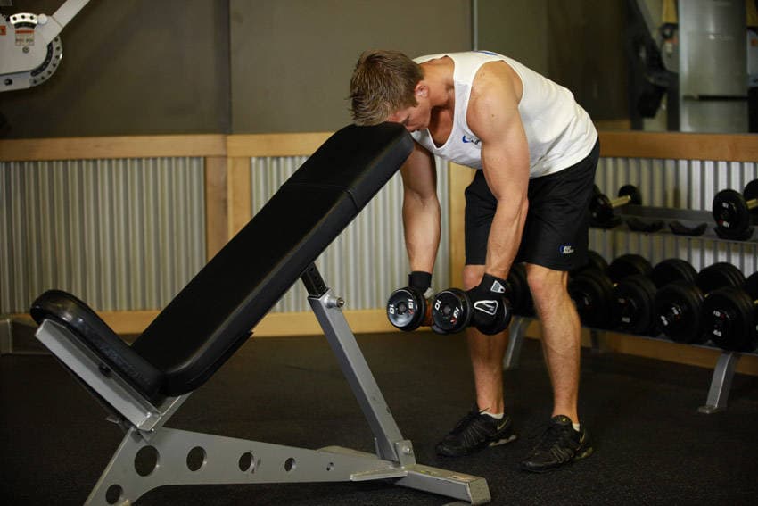 Bent Over Dumbbell Rear Delt Raise With Head On Bench — starting position
