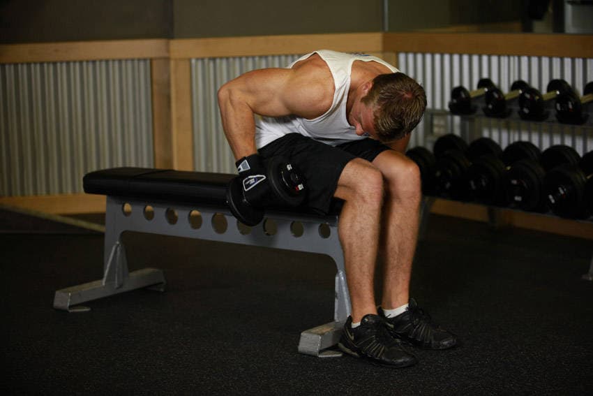 Seated Bent-Over One-Arm Dumbbell Triceps Extension — starting position