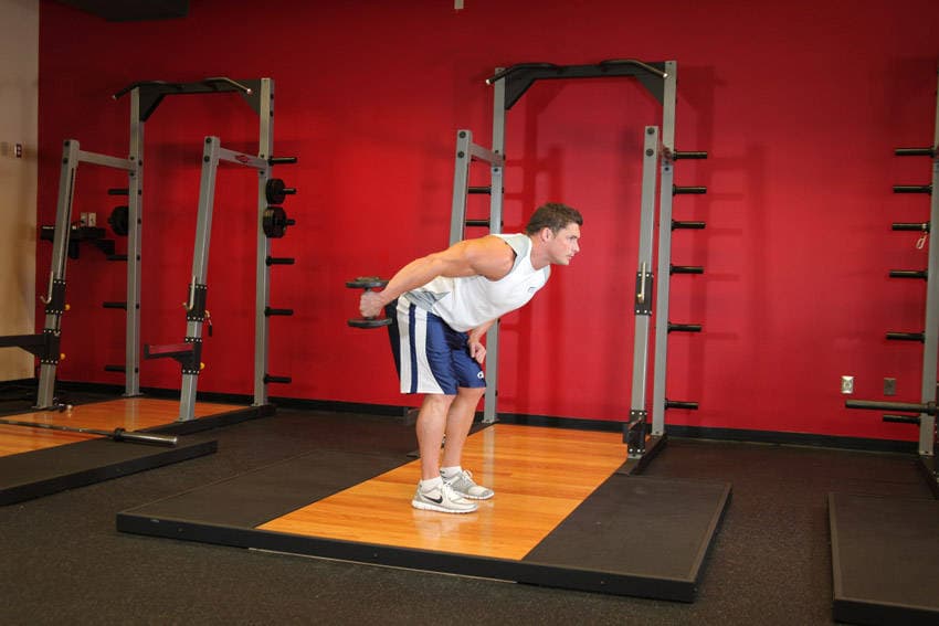 Standing Bent-Over One-Arm Dumbbell Triceps Extension — end position